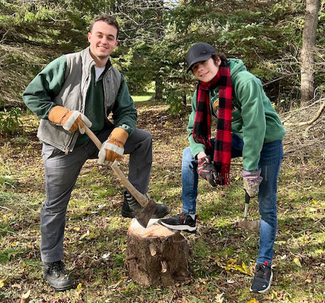 A big and little cutting wood on a fall day