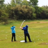 two guys at the golf range on a colourful fall day